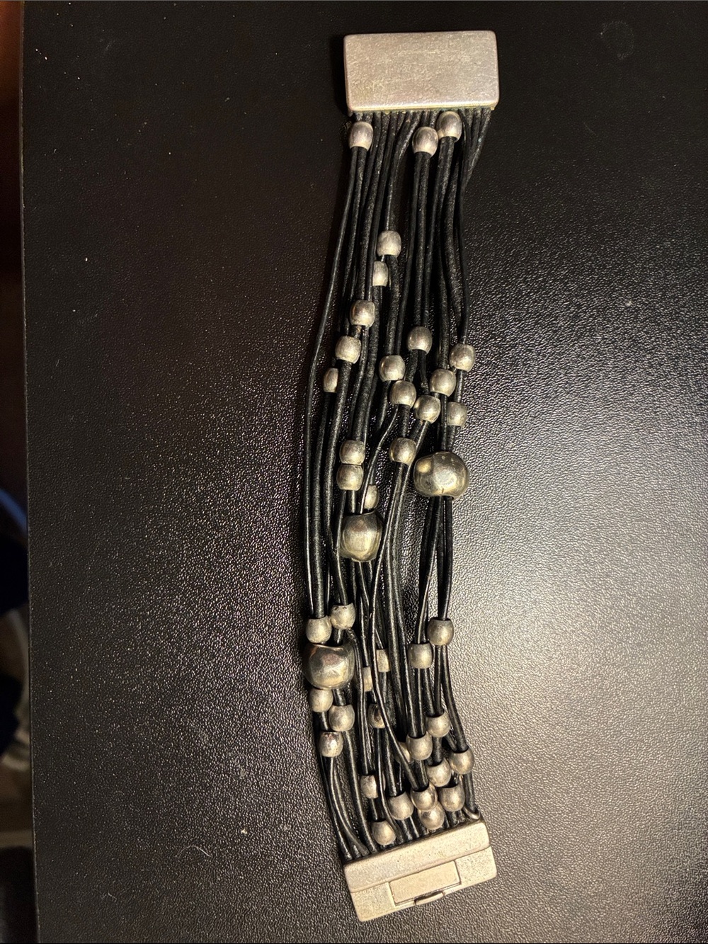 Multi-Strand Black Leather Bracelet with Silver Beads and magnetic closure.